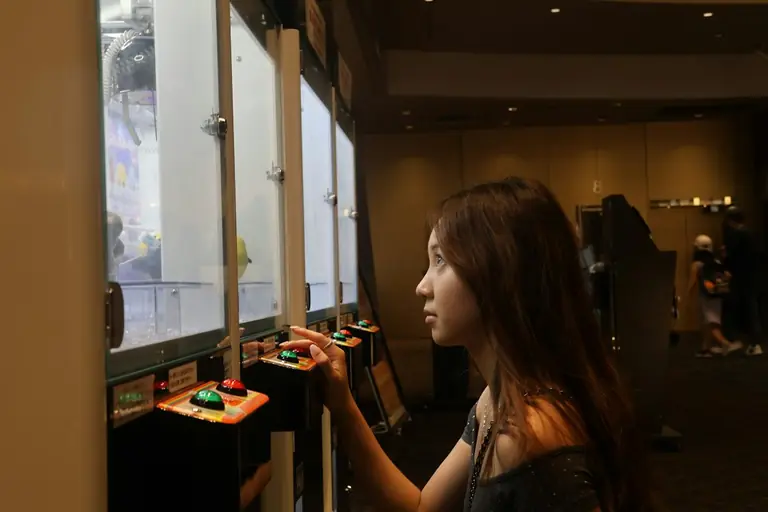A woman standing in front of a display of cupcakes