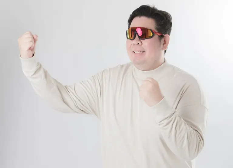Asian man in sunglasses posing confidently on a white background.